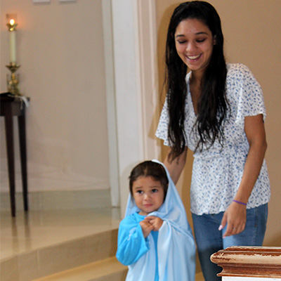 A woman and a kid wearing a blue dress