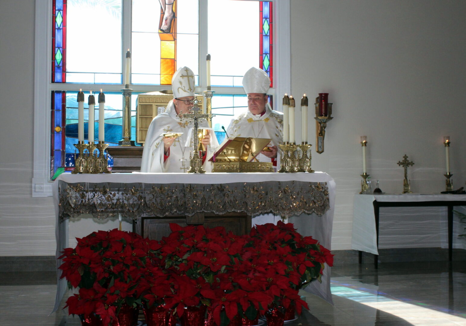 A bishop and a priest doing the communion ceremony
