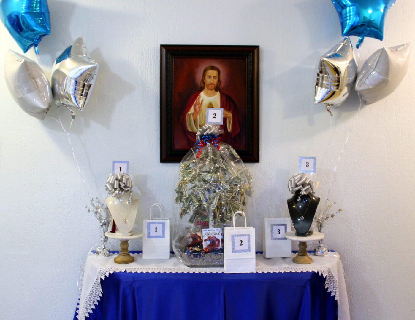 A table with white and blue table clothes and gifts