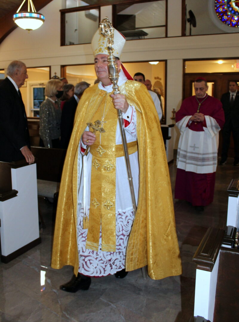 A bishop wearing a gold vest