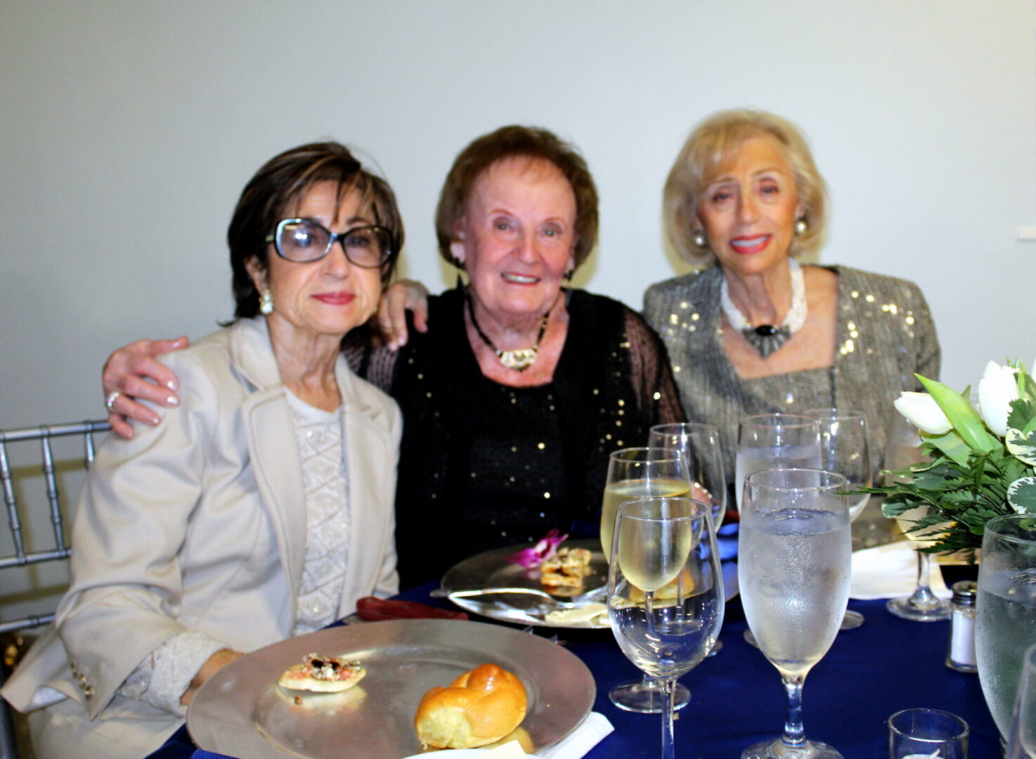Three women wearing formal attire