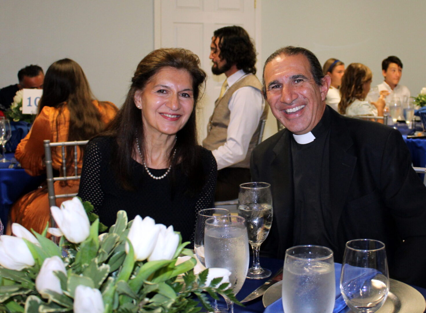 A man and a woman wearing black outfits