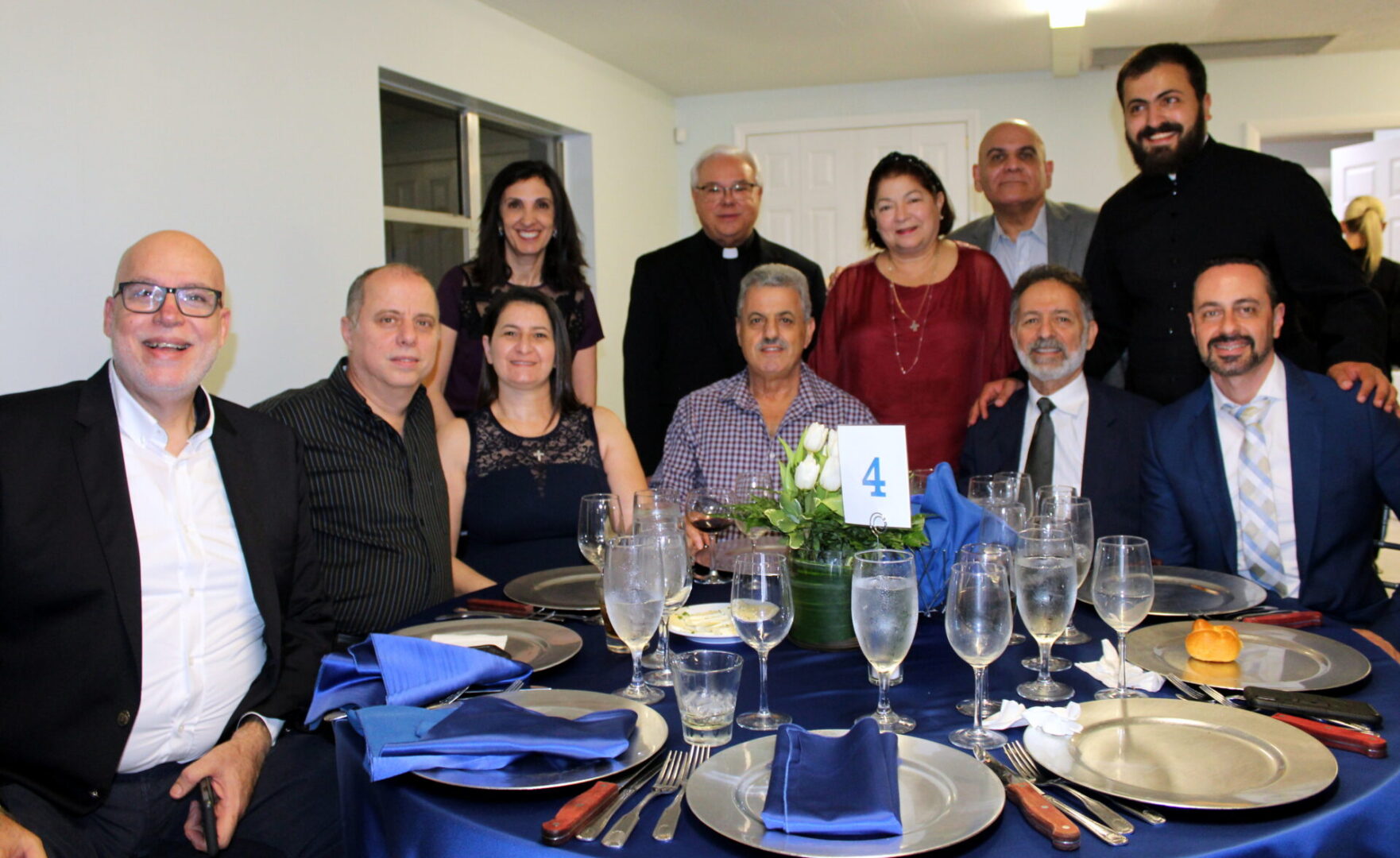 A group of people wearing formal attires on table number 4