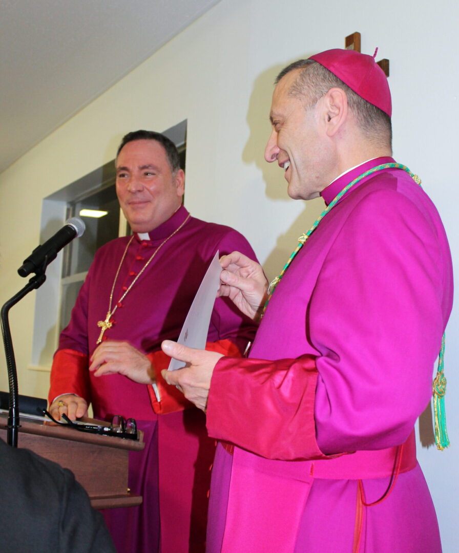 Two church people wearing purple attire