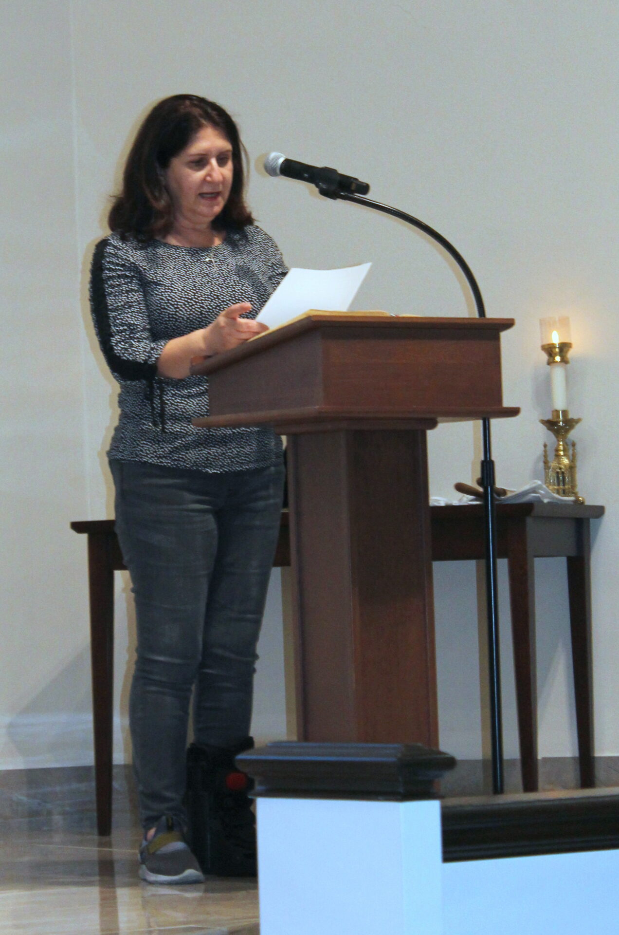 A woman wearing a gray top and pants