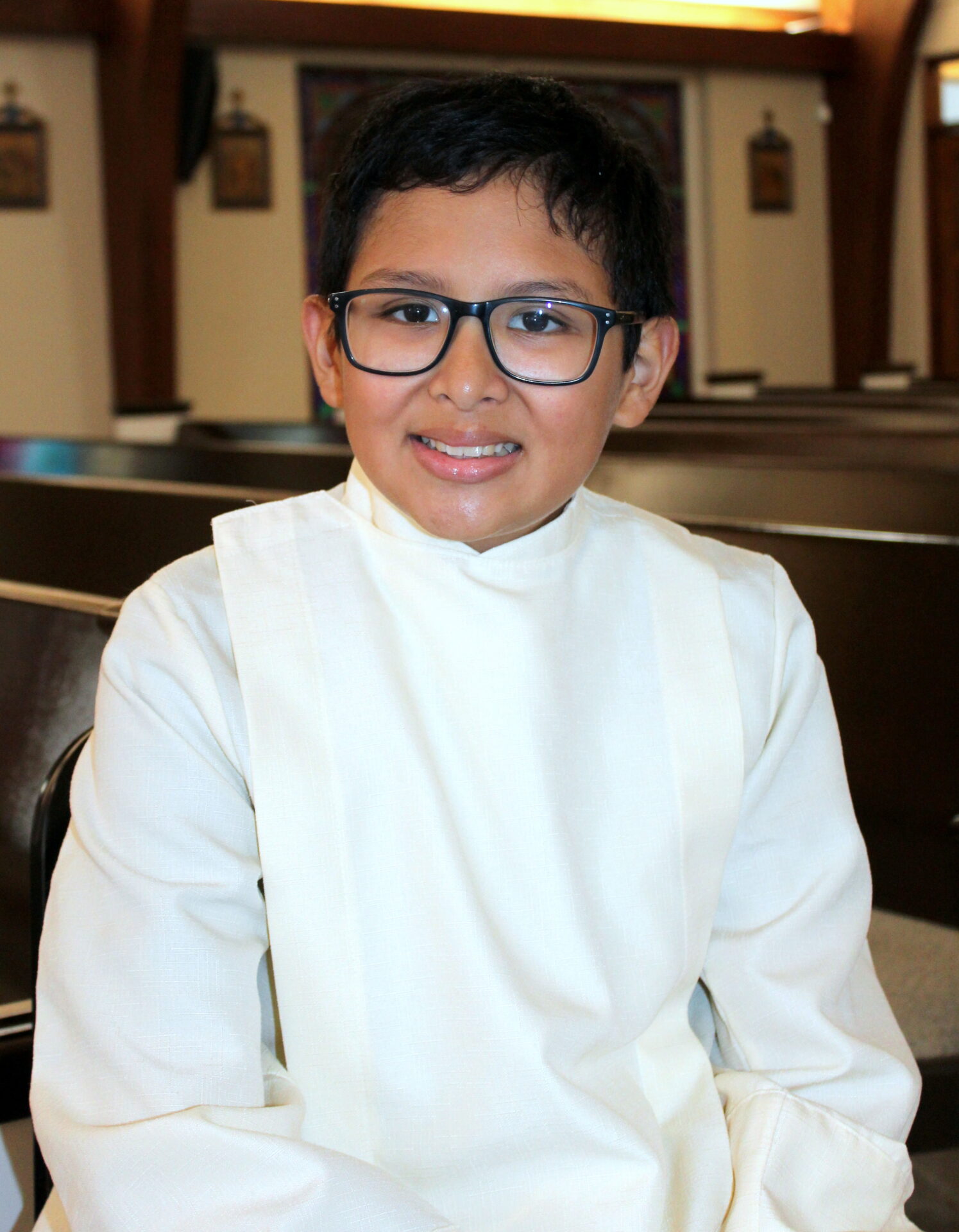 A young boy wearing a black eyeglass
