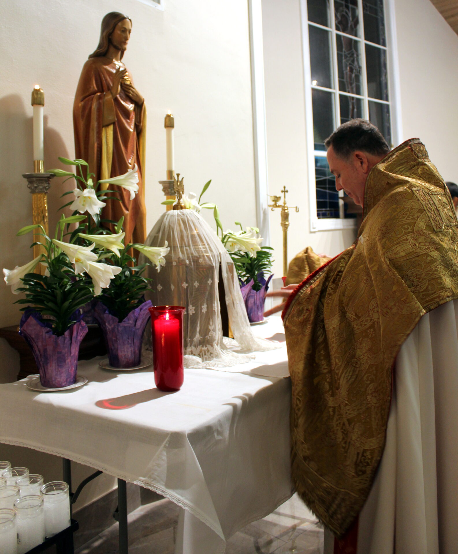 The priest praying at the altar