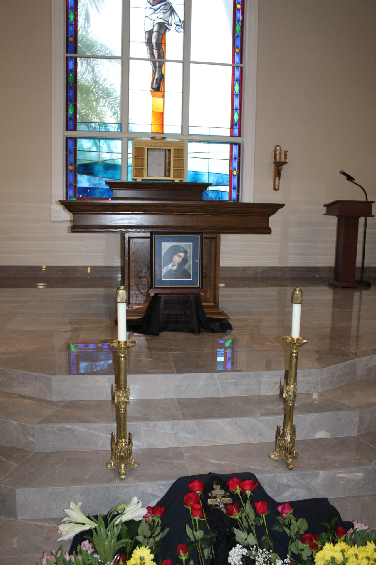 Two gold candle holders in front of the altar