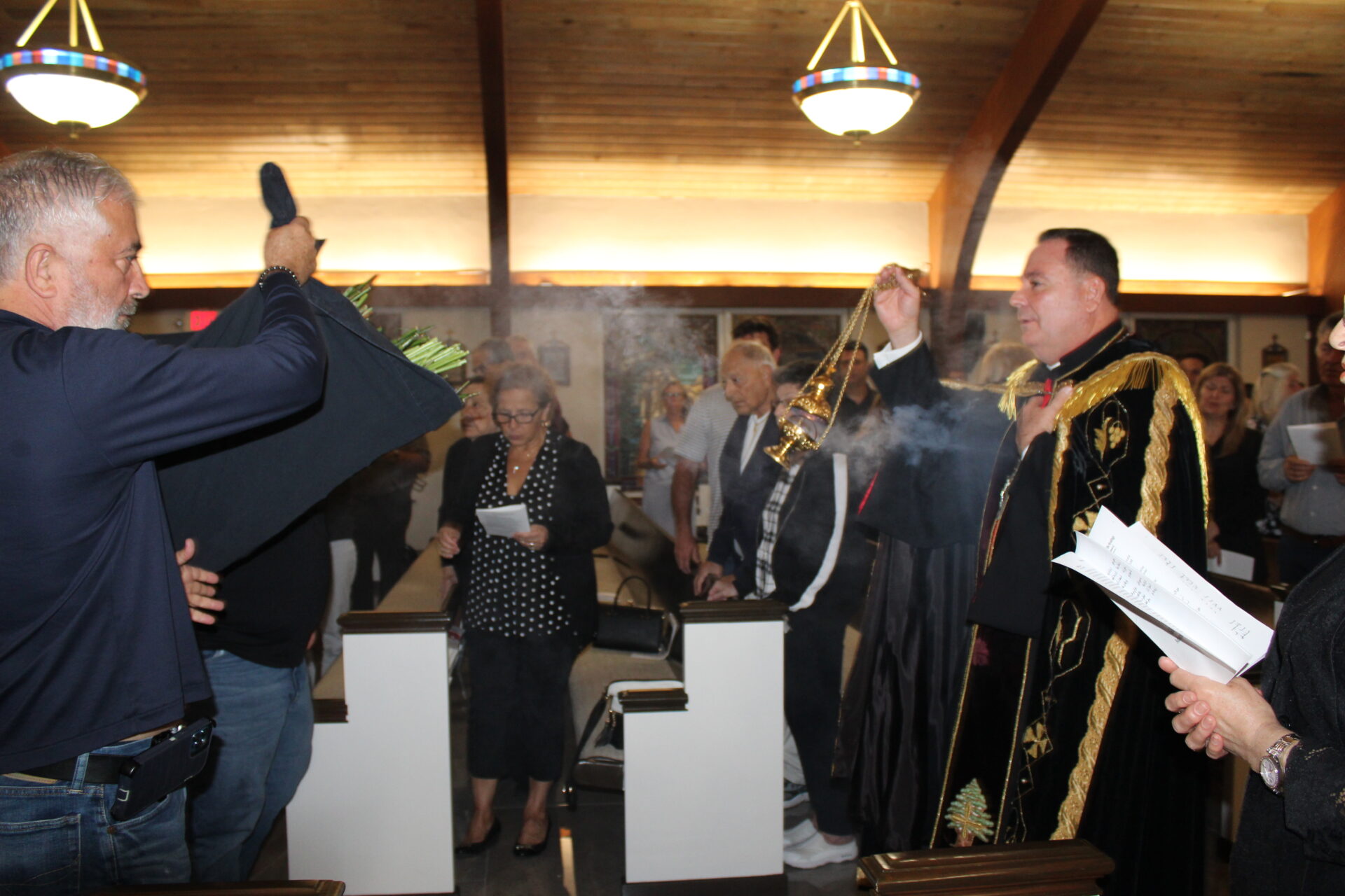 A group of people wearing black and white outfit during the mass