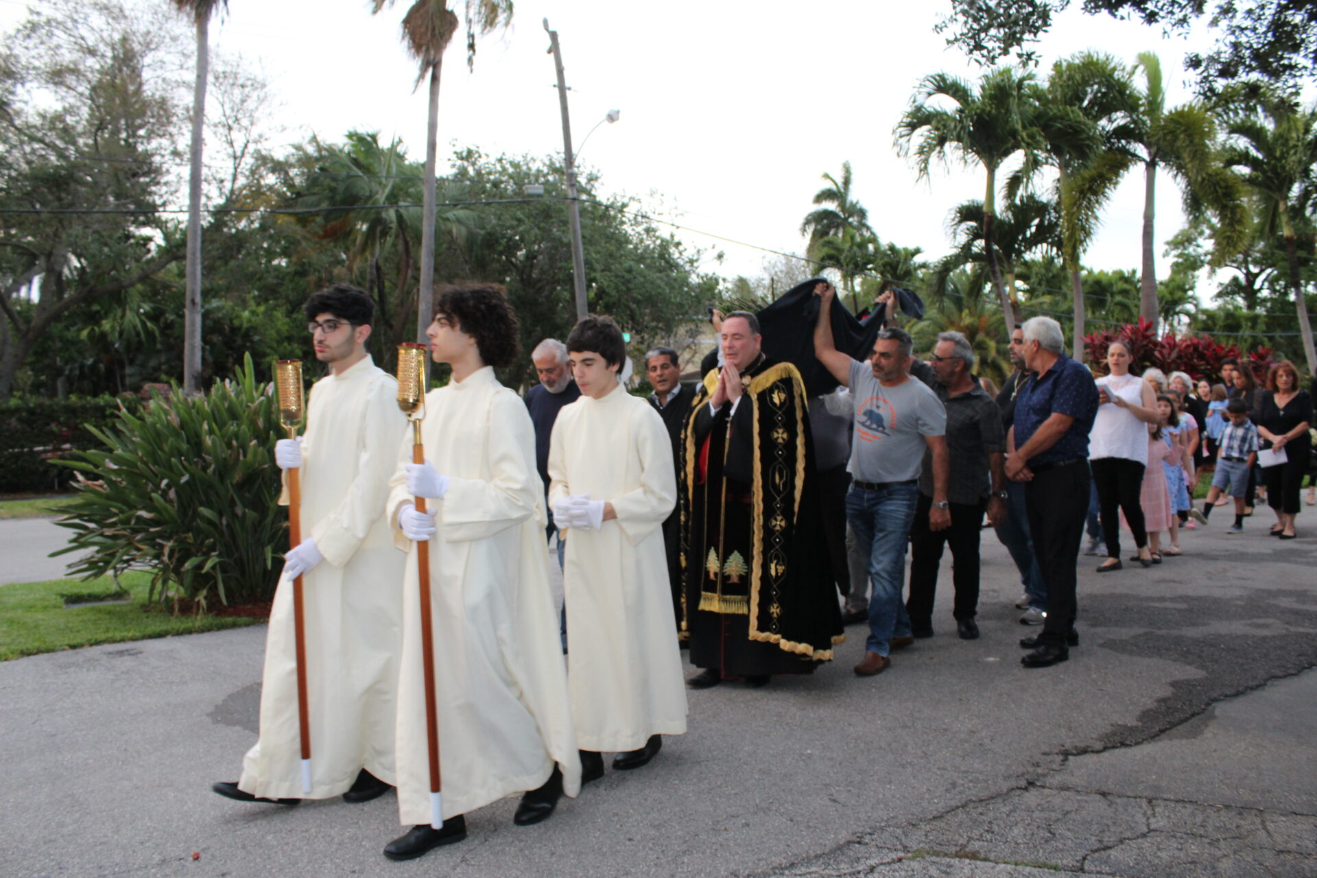 A parade with three sacristans in front