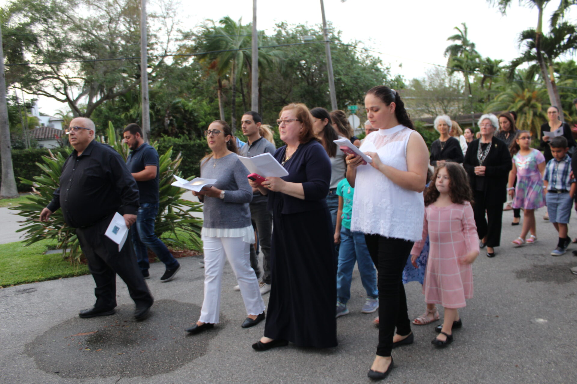 Three ladies in front of the line while holding papers