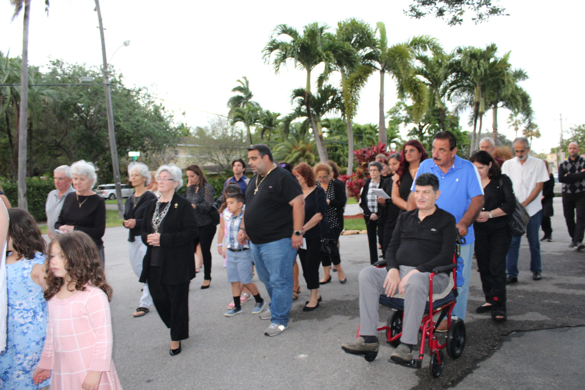 A man wearing a black top and gray pants while on his wheelchair