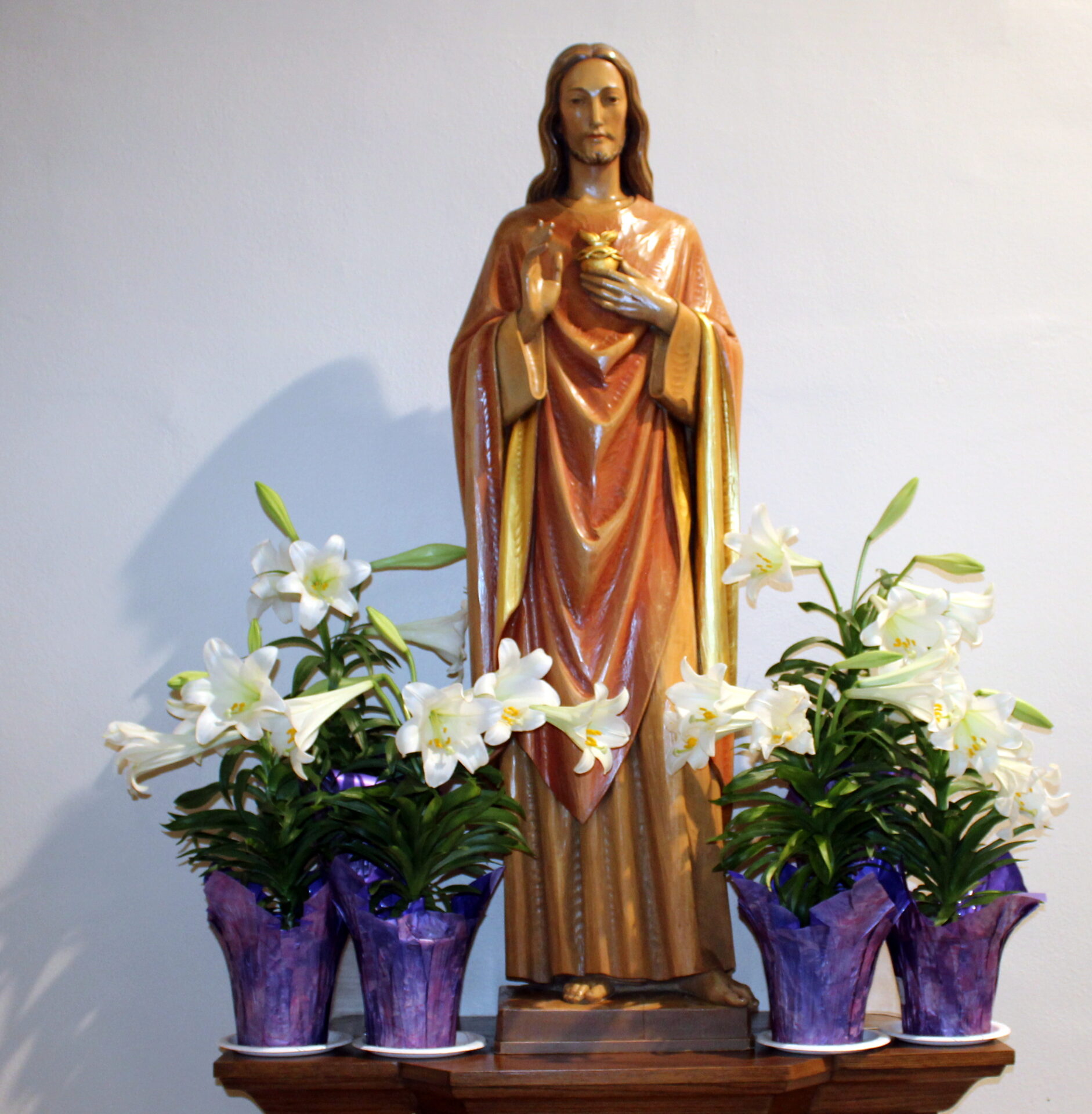 An altar with four purple flower vases