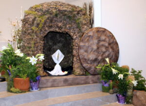 An open stone tomb with white cloth