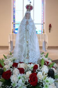 A statue of Mary with white dress